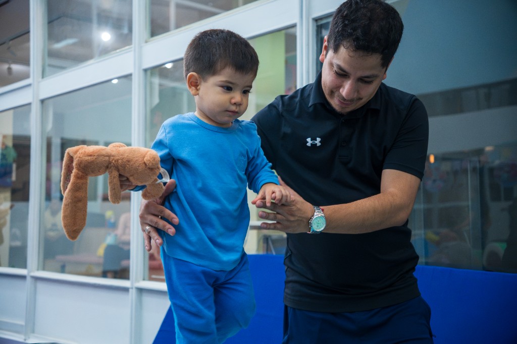 Alumno caminando con acompañamiento en Fly Gym